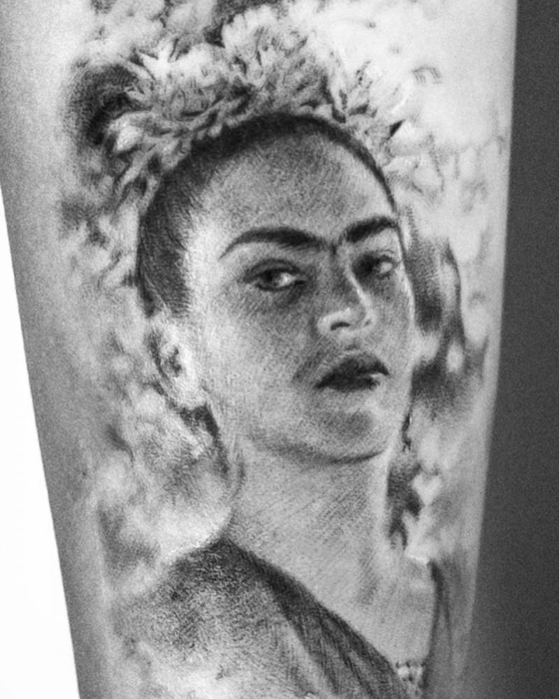 Micro-realistic Frida Kahlo portrait tattoo located on the inner forearm.