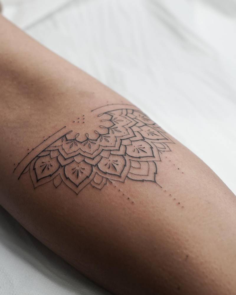 Half mandala tattoo located on the inner forearm.