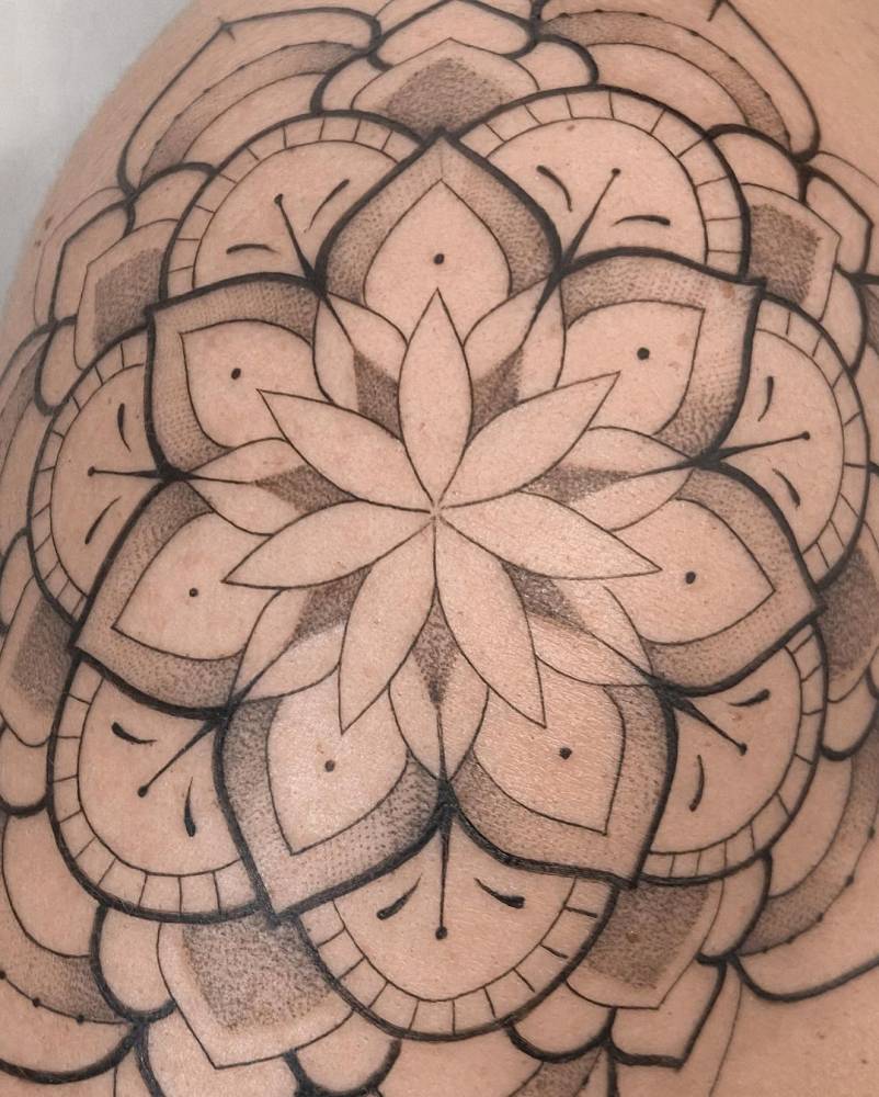 Mandala tattoo on the shoulder.