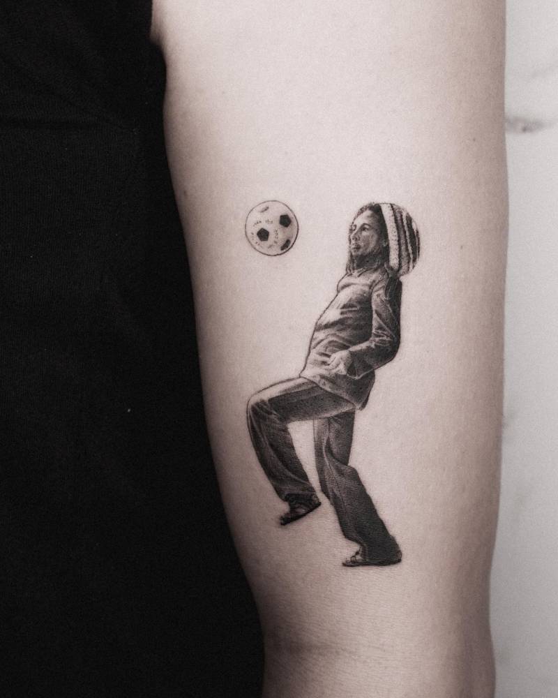 Micro-realistic Bob Marley tattoo done on the upper arm.