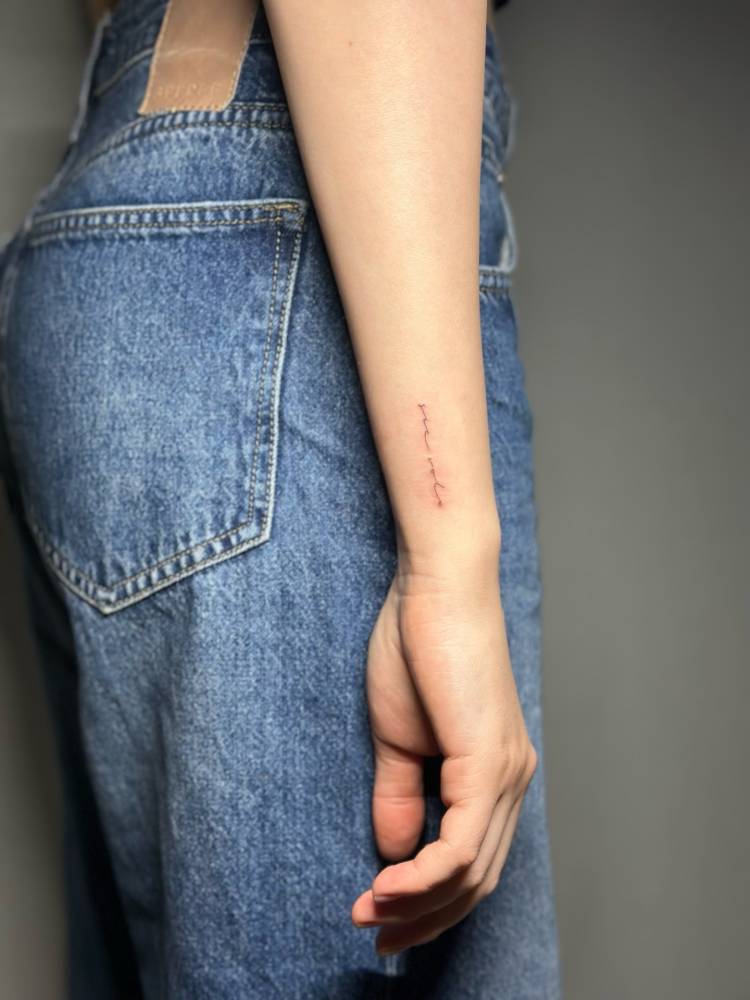 "Sic volo" lettering tattoo located on the wrist.