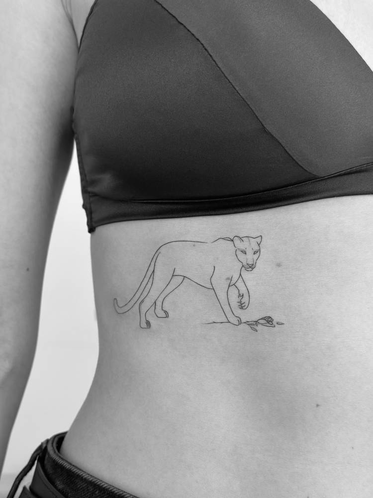 Panther tattoo placed on the rib, done in fine line style.