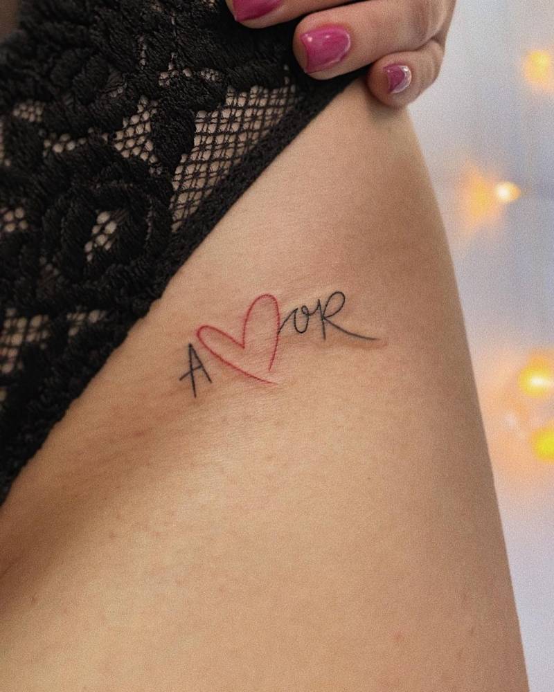 Tattoo of the word "amor" located on the pelvis.