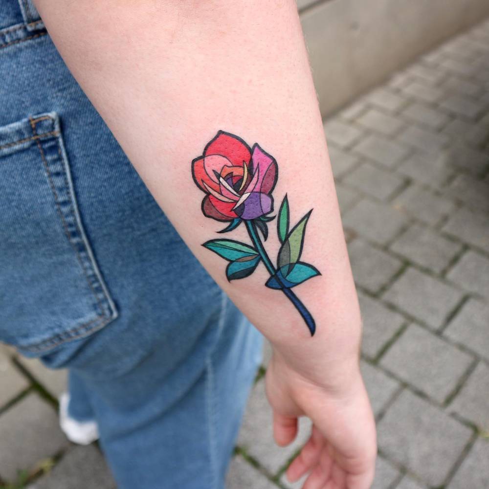 Pop art style rose tattoo located on the forearm.