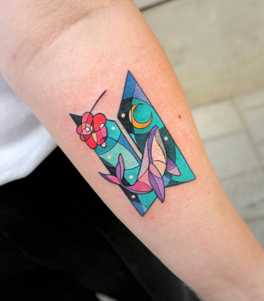 Pop art style whale and stained glass tattoo located on the inner forearm.