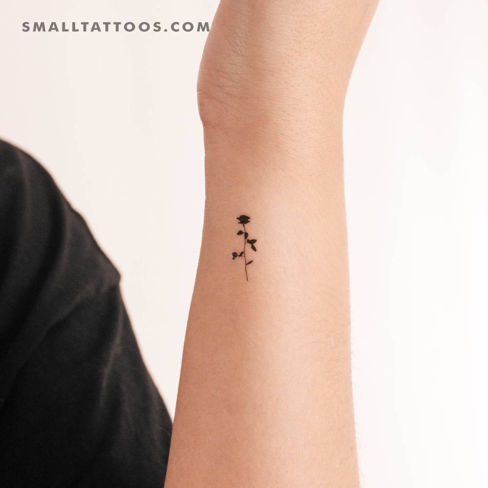 Small black rose temporary tattoo placed on the wrist.