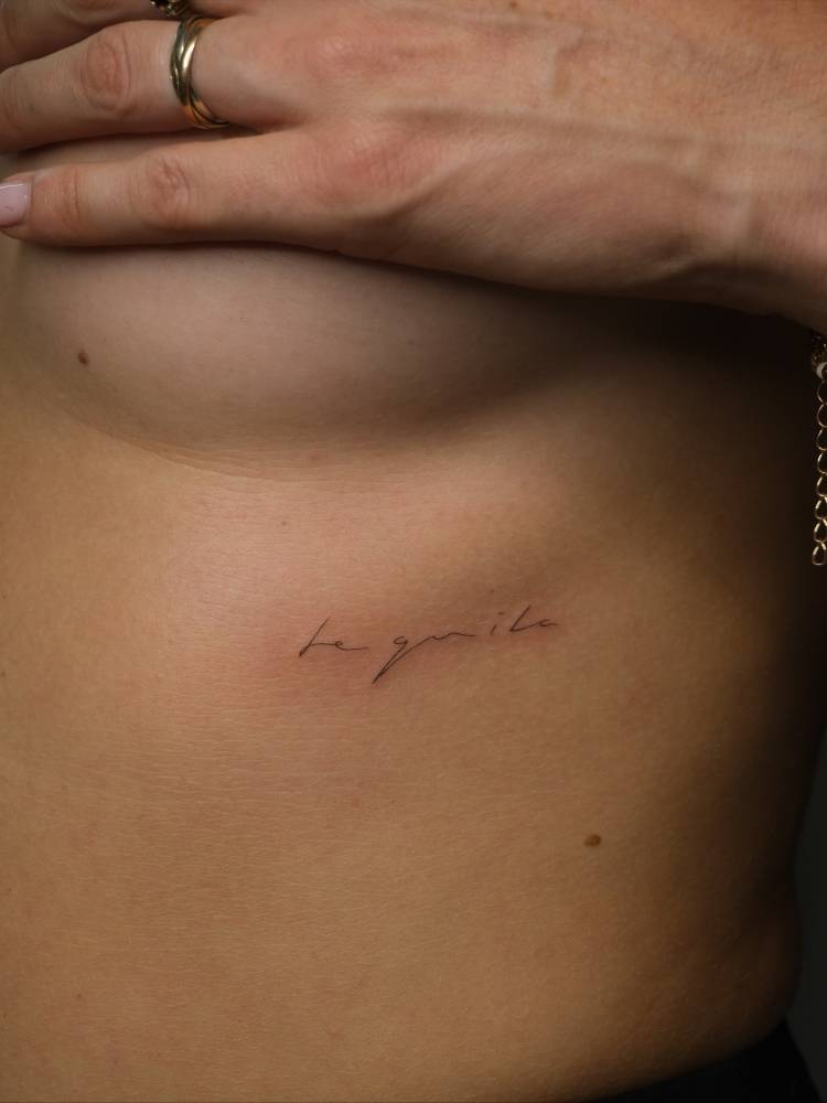 "Tequila" lettering tattoo handwritten on the rib.
