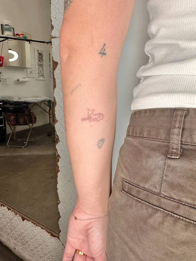 Fawn tattoo in fine line style located on the inner forearm.
