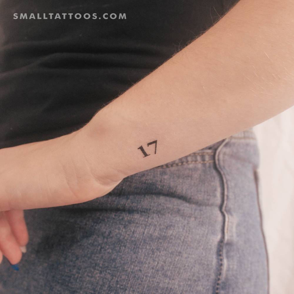 Serif font number "17" temporary tattoo located on the wrist.