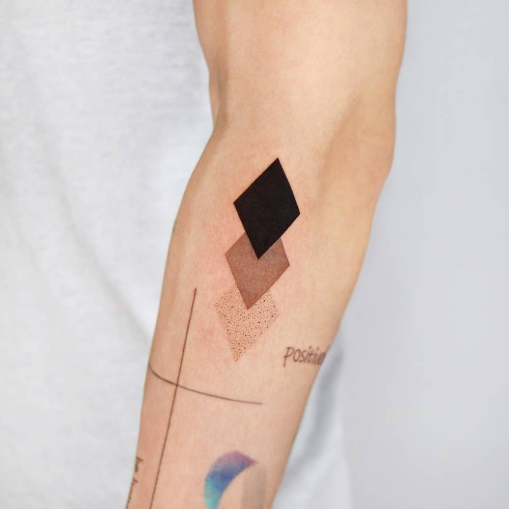 Geometric style rhombus tattoo located on the forearm.