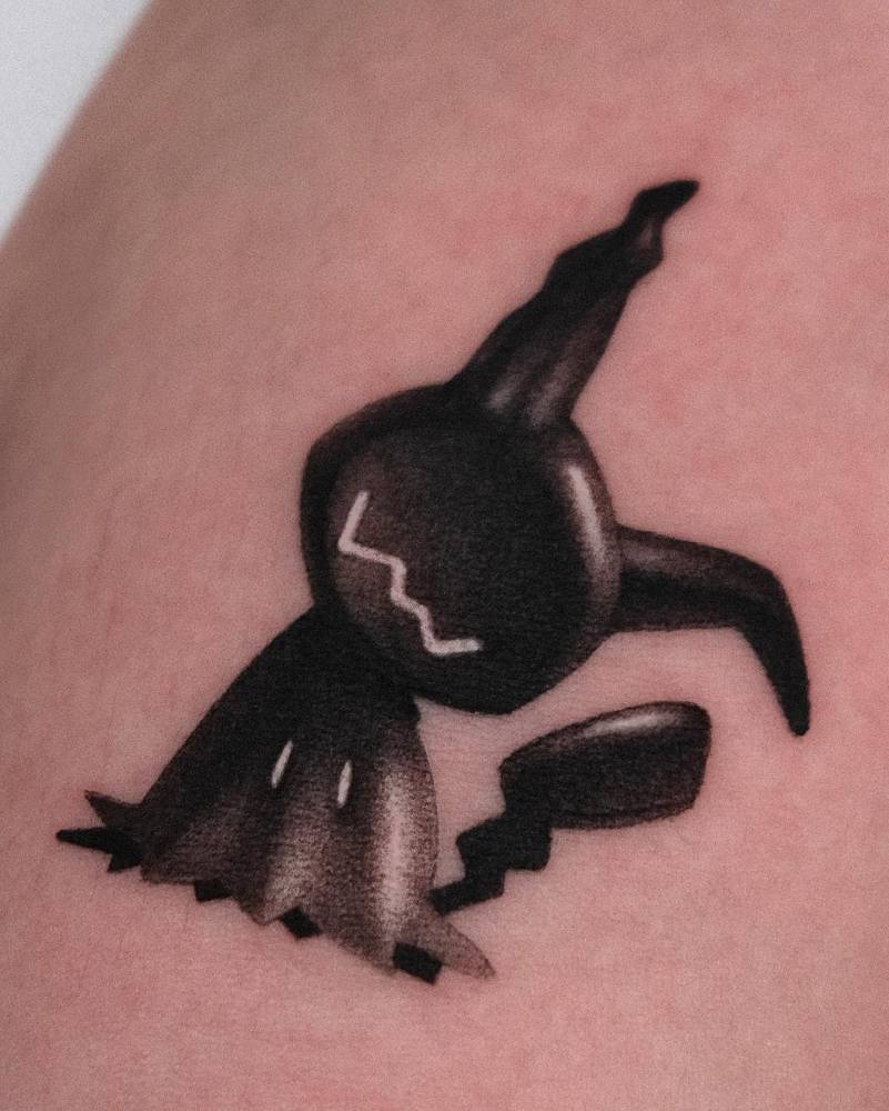 Pop art style Mimikyu tattoo located on the inner forearm.