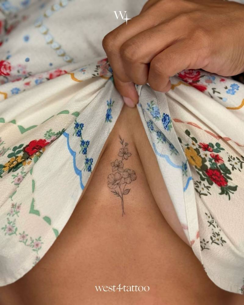 Flower bouquet tattoo located on the sternum.