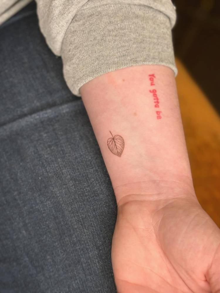 Little leaf tattoo in illustrative style done on the wrist.