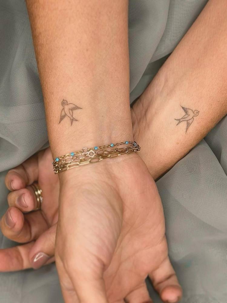 Matching fine line style swallow tattoo for best friends.