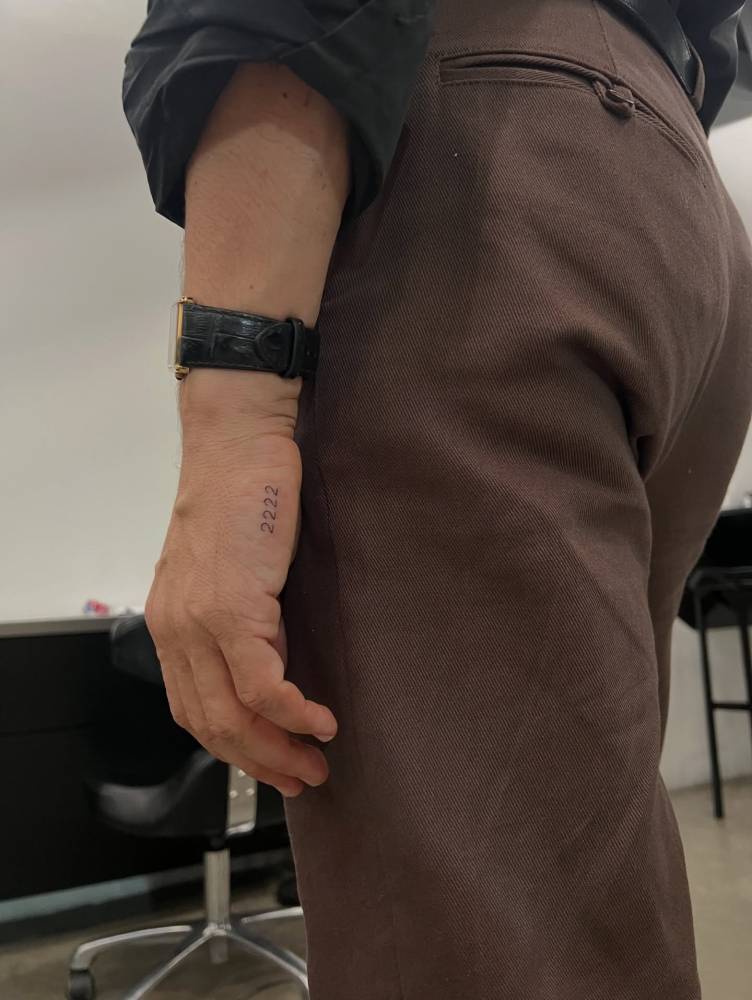 Angel number "2222" tattoo located on the hand.