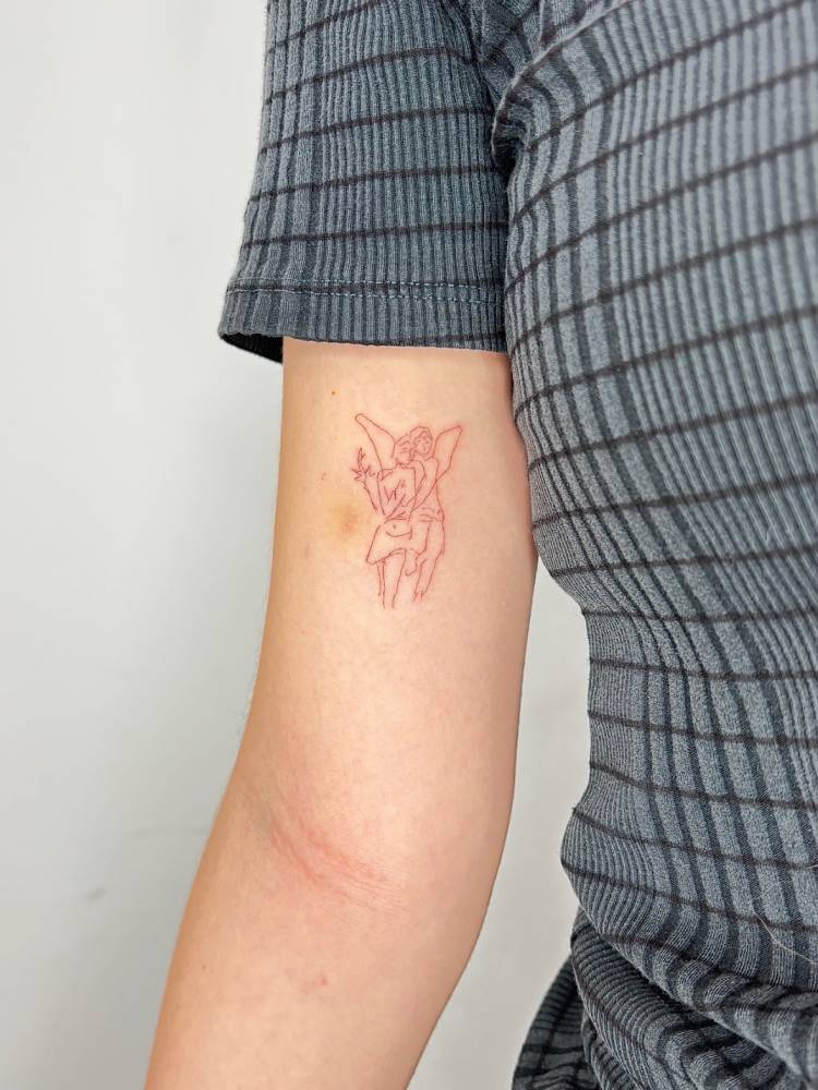 Fine line style 'The Abduction of Psyche' tattoo located on the inner arm.