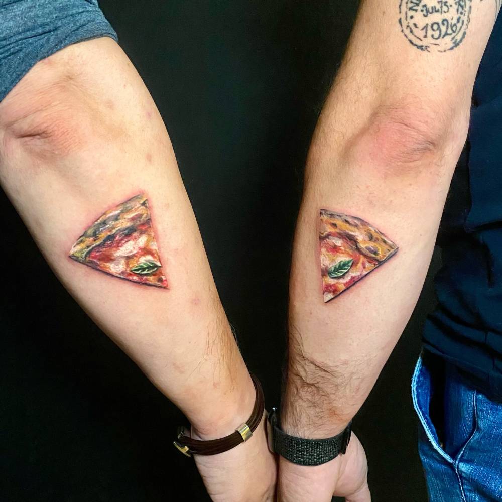 Matching micro-realistic pizza margherita tattoo for best friends.