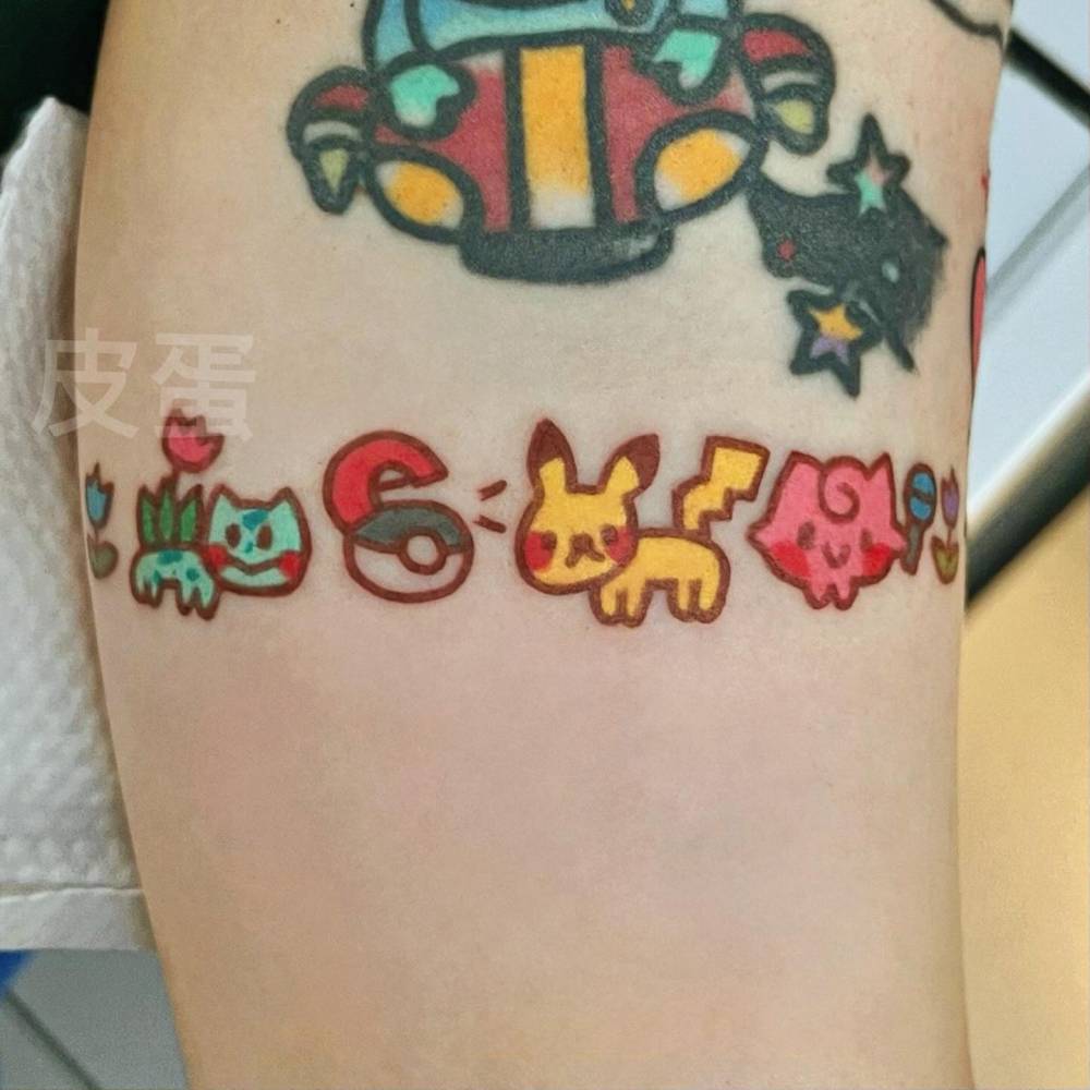 Cartoon  style Pokemon tattoo located on the inner arm.