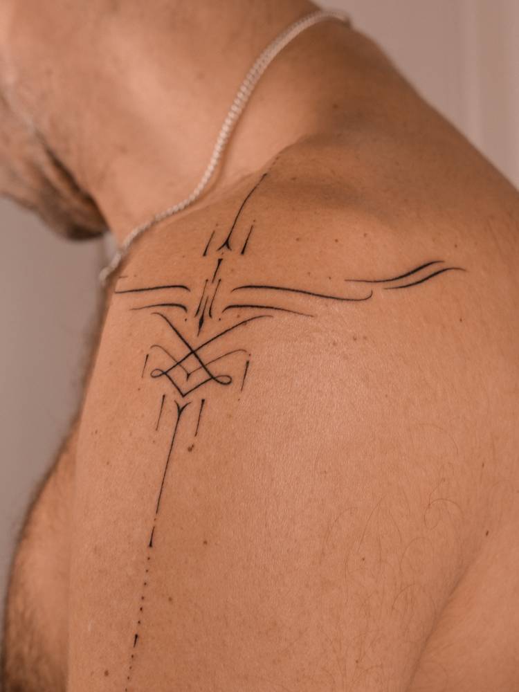 Ornamental design tattooed on the shoulder.