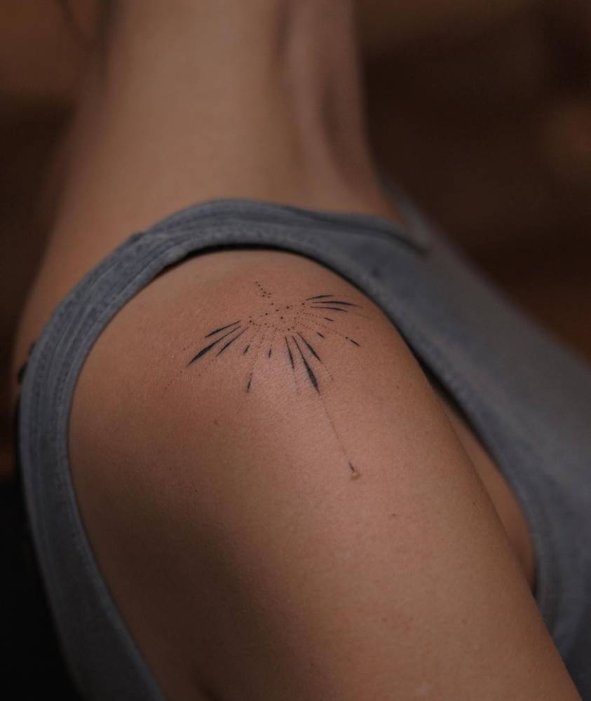 Ornamental tattoo in hand poked style done on the shoulder.