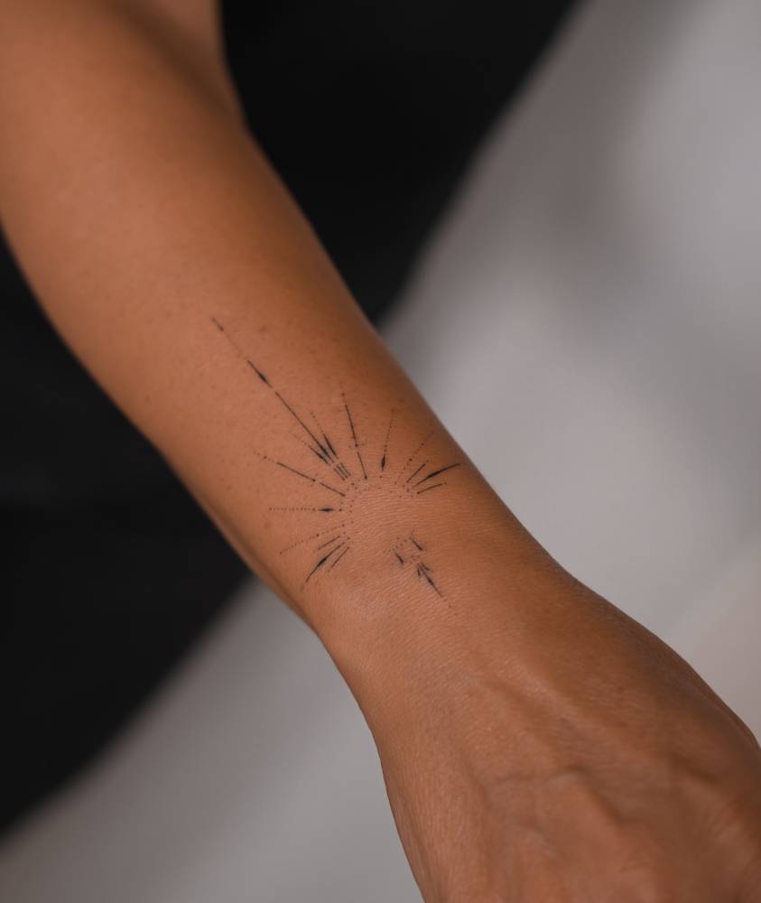 Ornamental tattoo located on the wrist, hand poked.