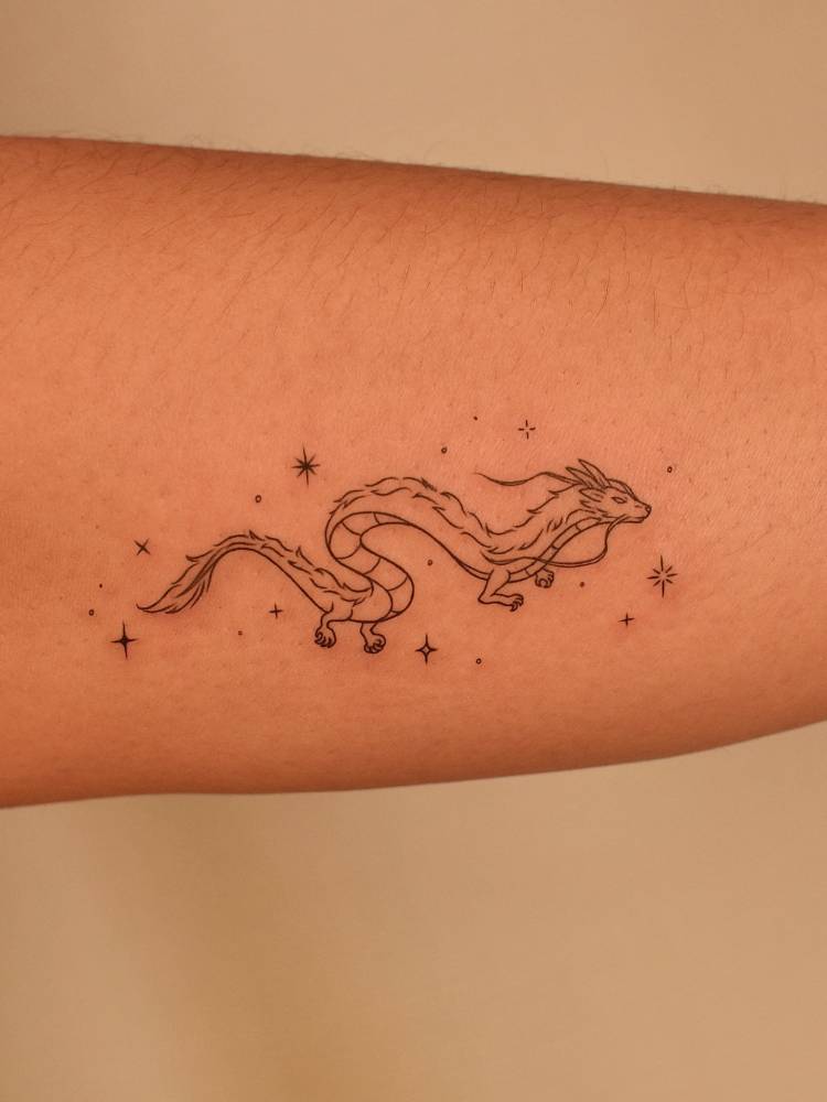 Haku dragon tattoo in fine line style located on the forearm.