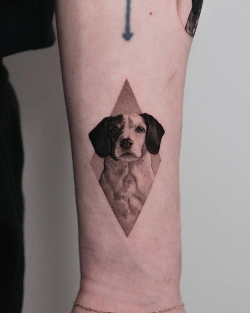 Micro-realistic style Beagle portrait tattoo located on the wrist.