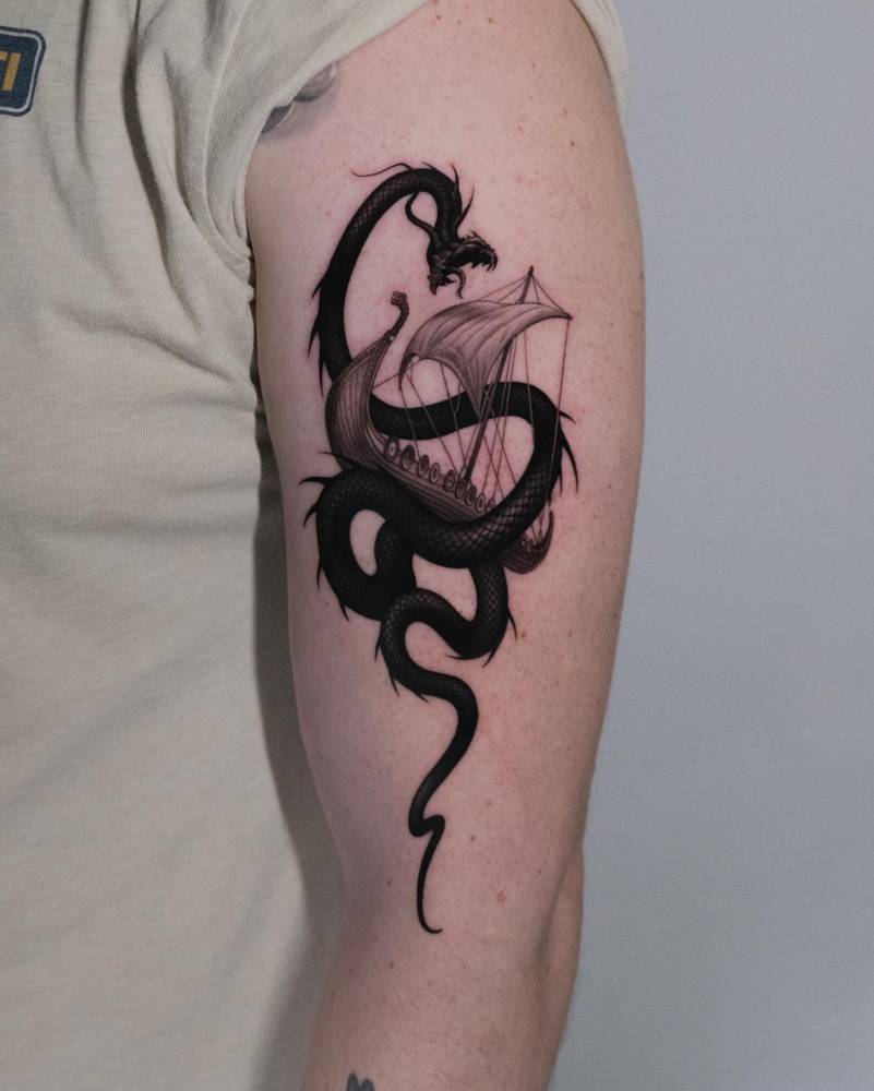 Jörmungandr tattoo located on the upper arm, micro-realistic style.