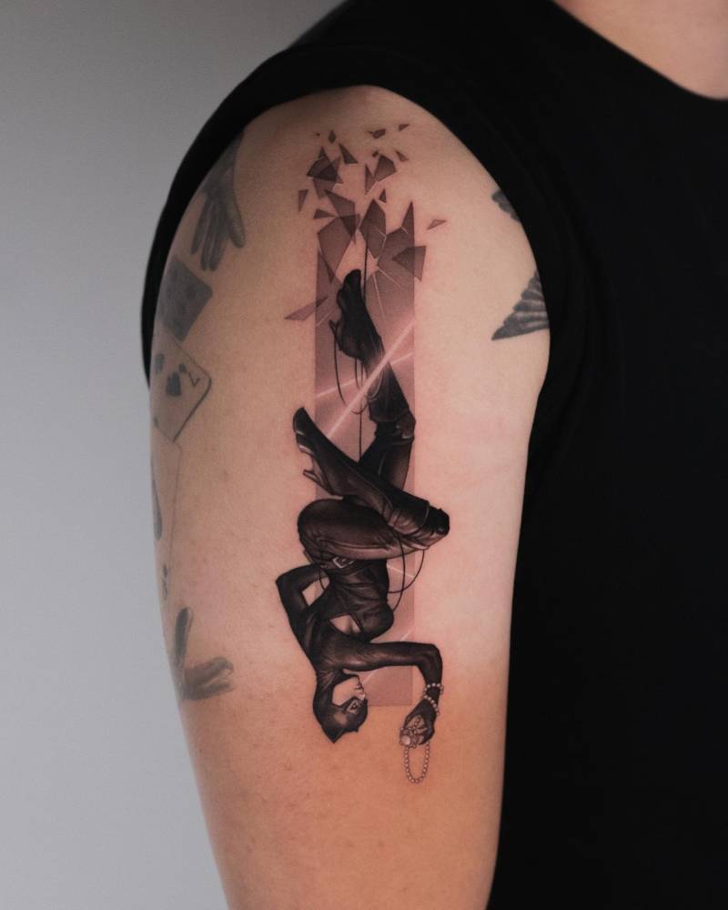 Catwoman tattoo located on the upper arm, micro-realistic style.