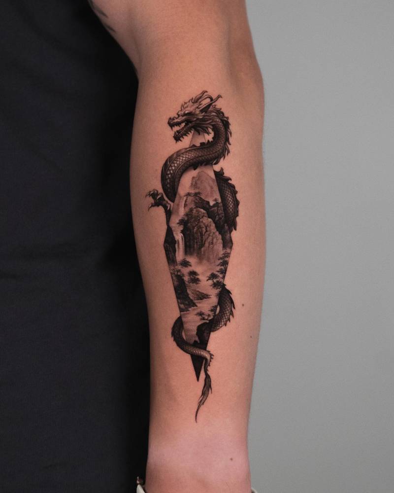 Dragon and landscape tattoo in micro-realism located on the forearm.