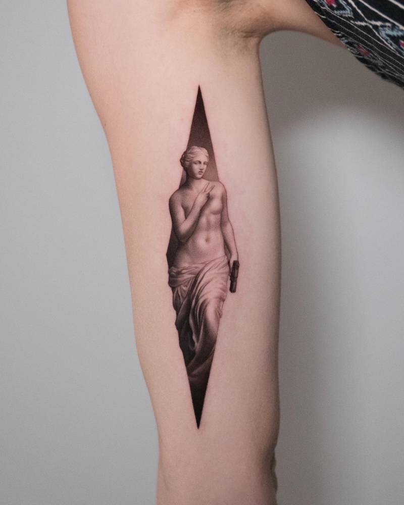 Venus de Milo tattoo in micro-realistic style placed on the inner arm.