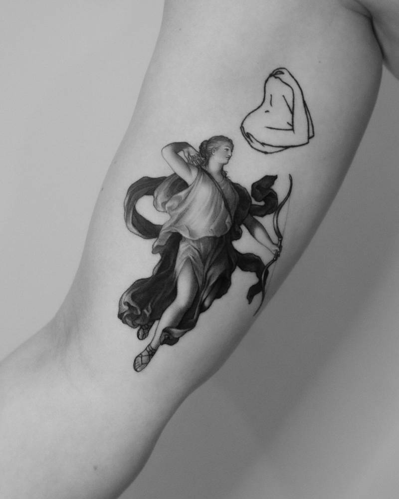 Cupid tattoo located on the inner arm, done in micro-realism.