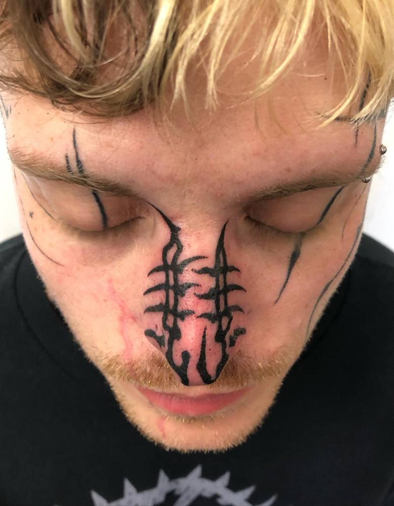 Tribal tattoo located on the face,
