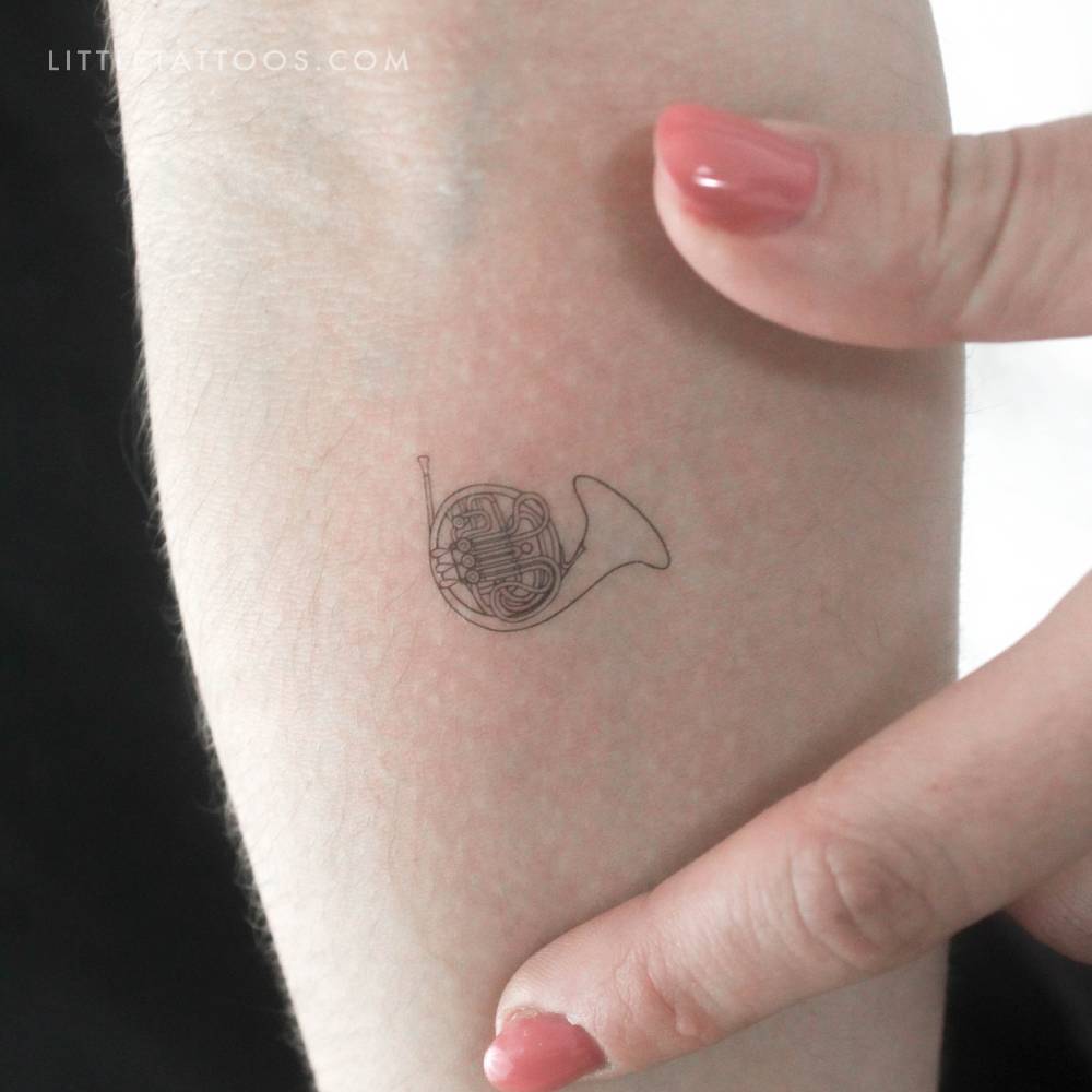 French horn temporary tattoo in fine line style.