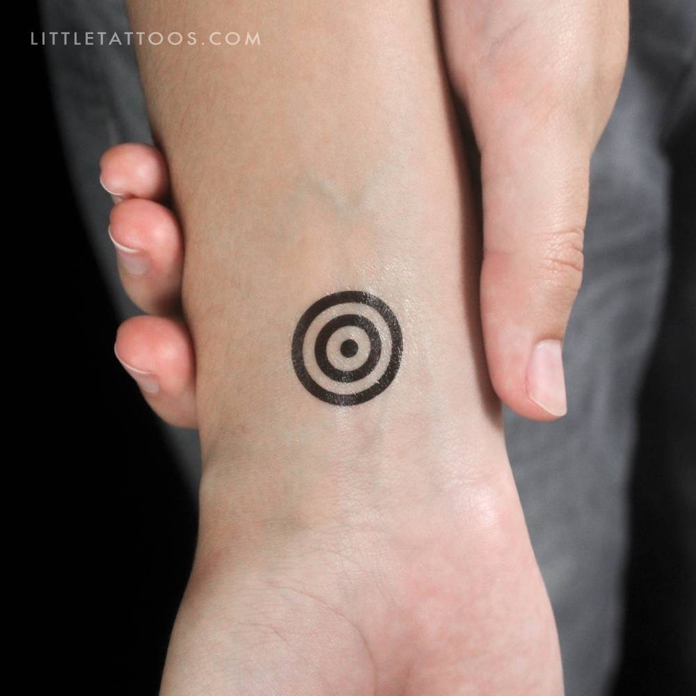 Minimalistic style target temporary tattoo located on the wrist.