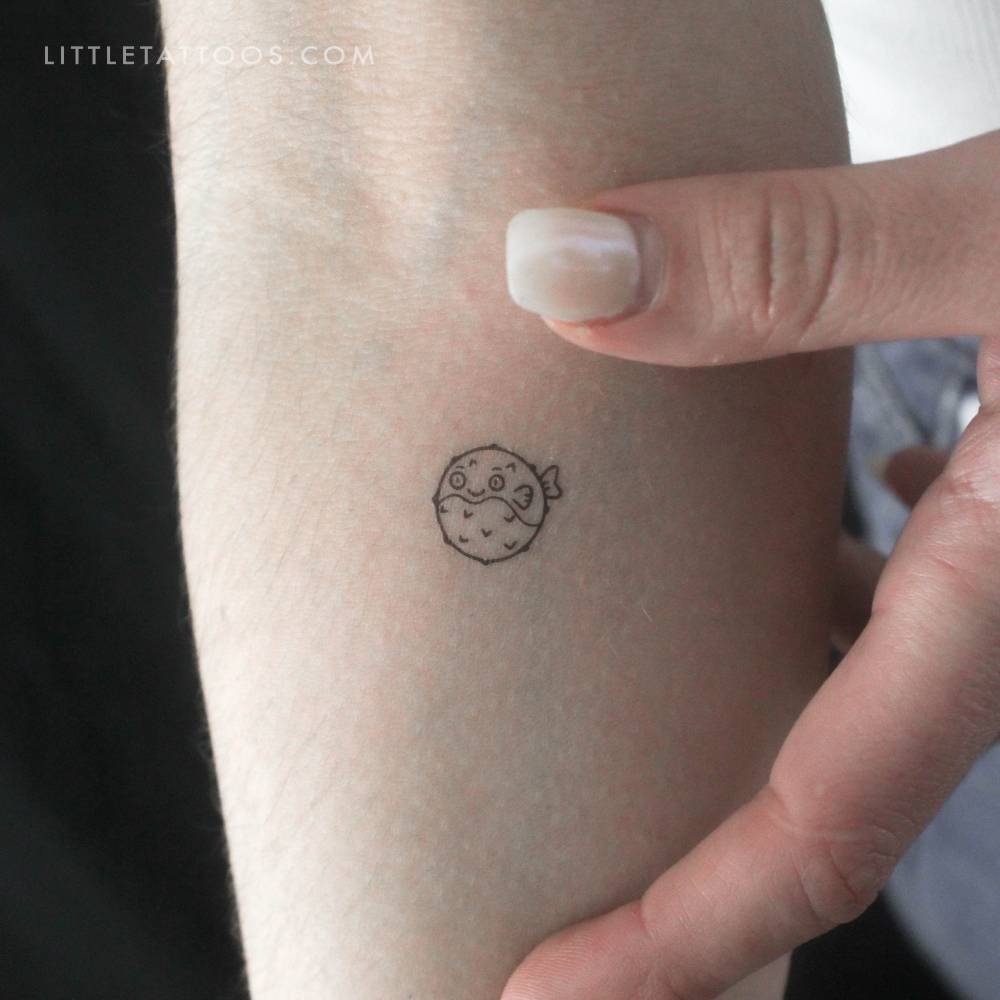 Puffed up pufferfish temporary tattoo located on the inner forearm.