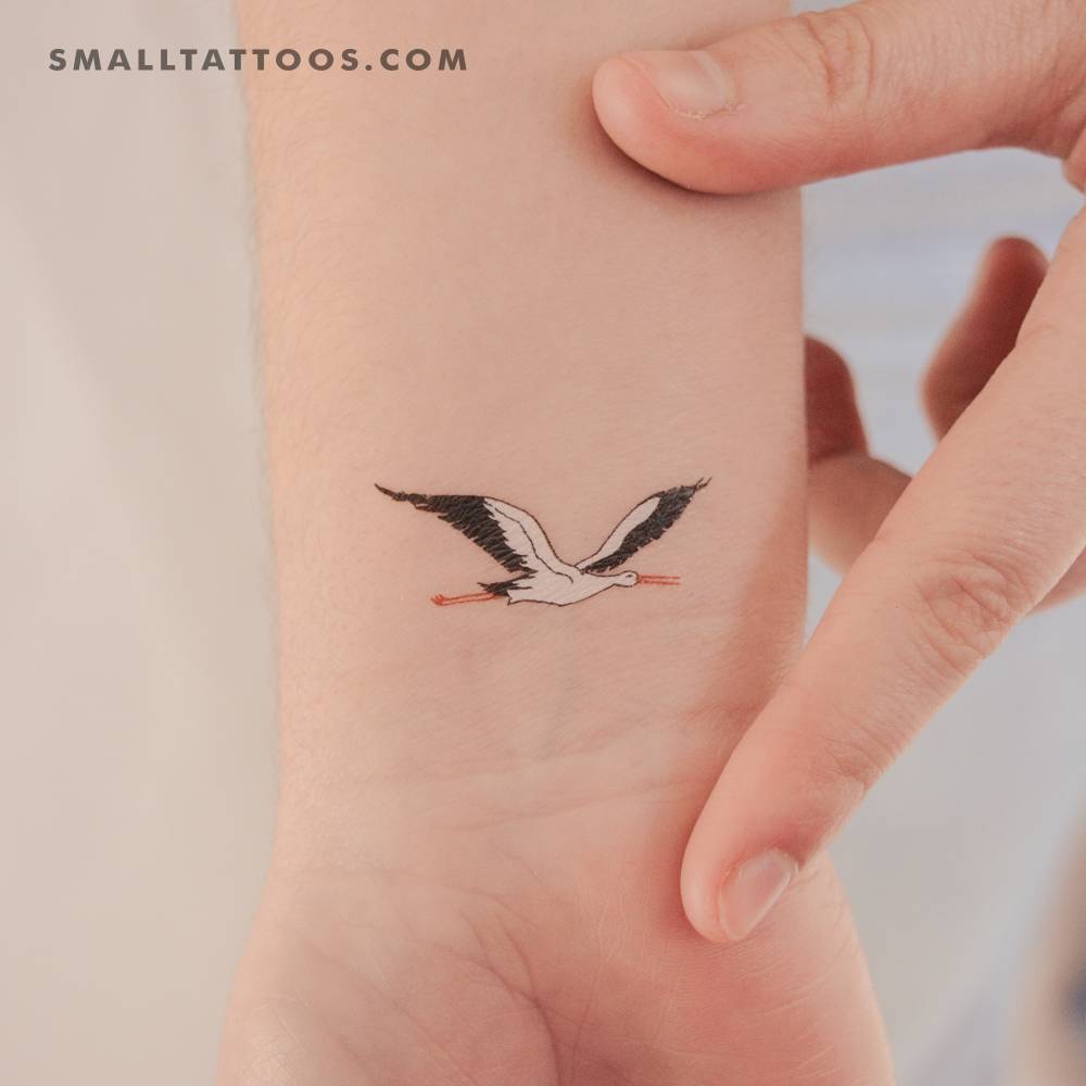 Flying stork temporary tattoo located on the wrist.