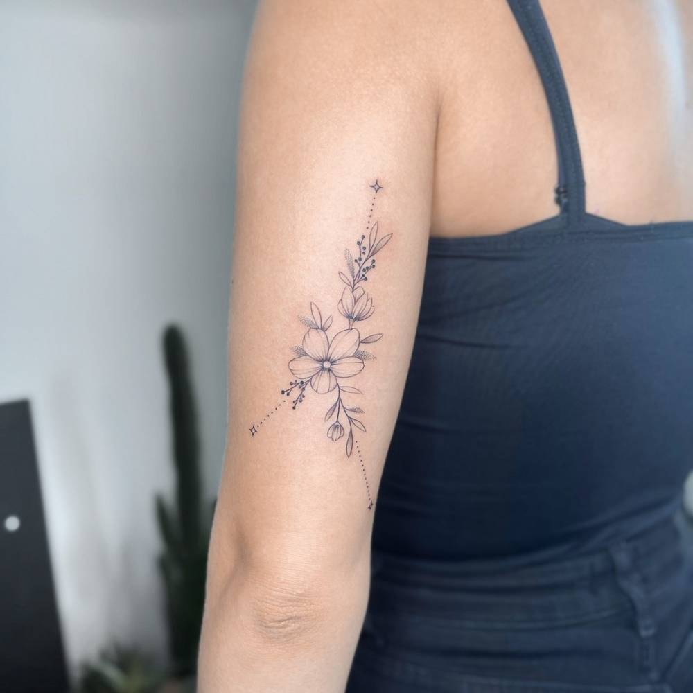 Floral Cancer constellation tattoo located on the tricep.