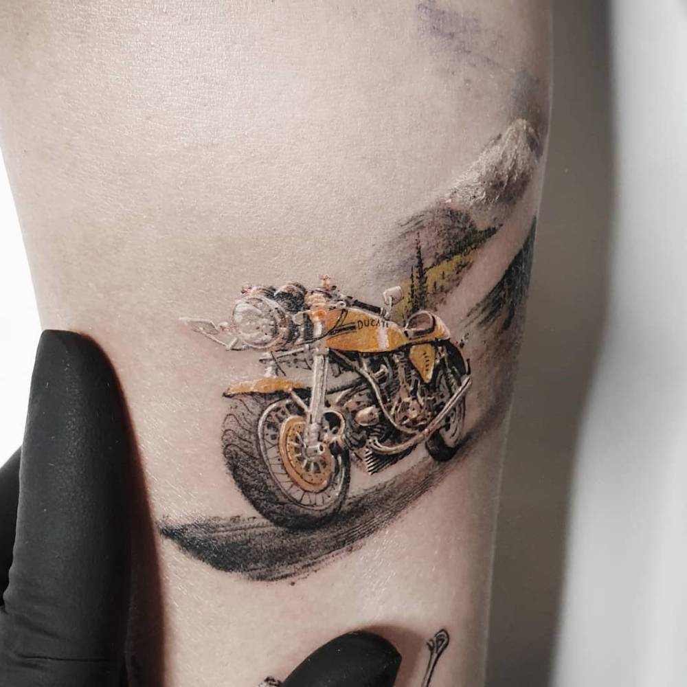 Micro-realistic style Ducati motorbike tattoo located on the inner forearm.