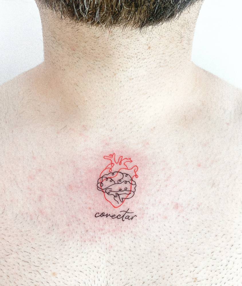 Heart vs brain with the word "conectar" tattooed on the collarbone.