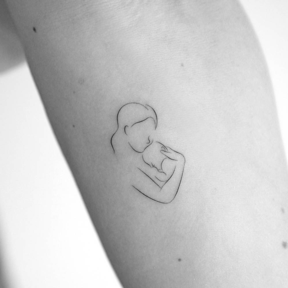 Motherhood tattoo located on the inner forearm, fine line style.