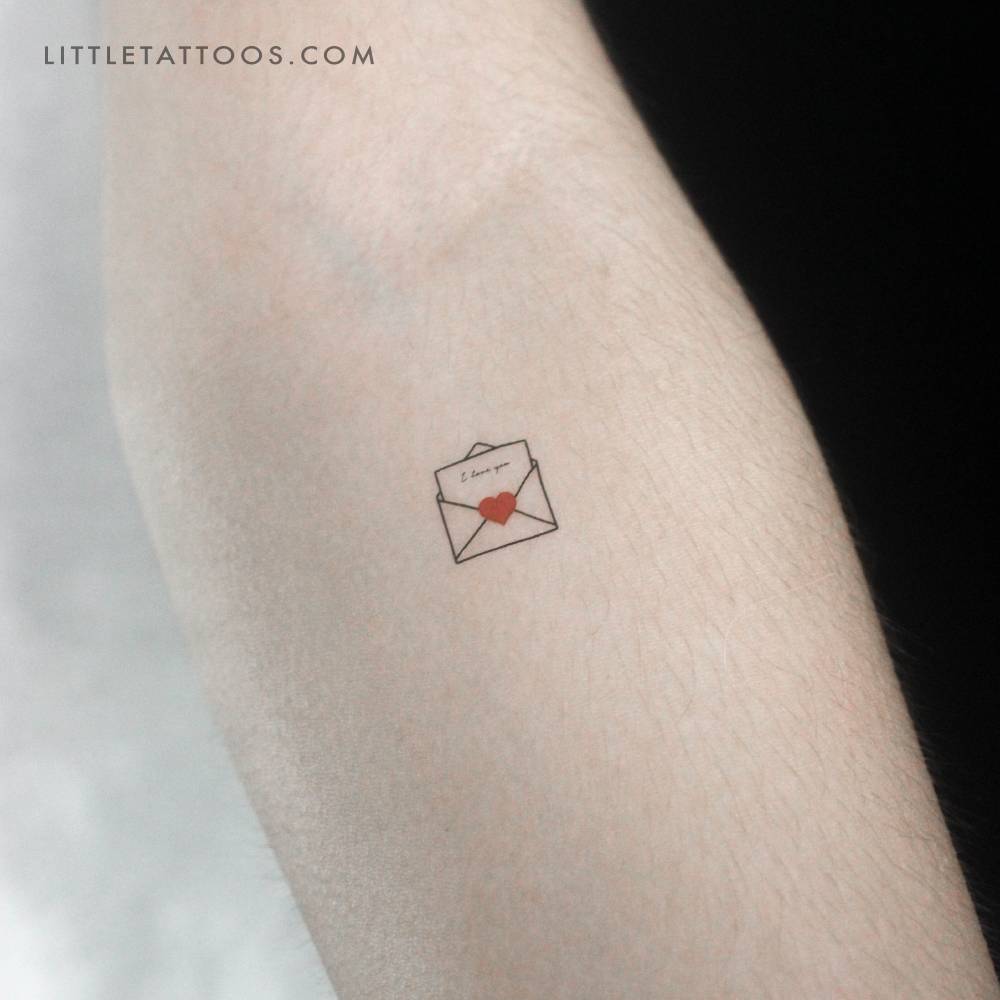 Open love letter temporary tattoo located on the inner forearm.
