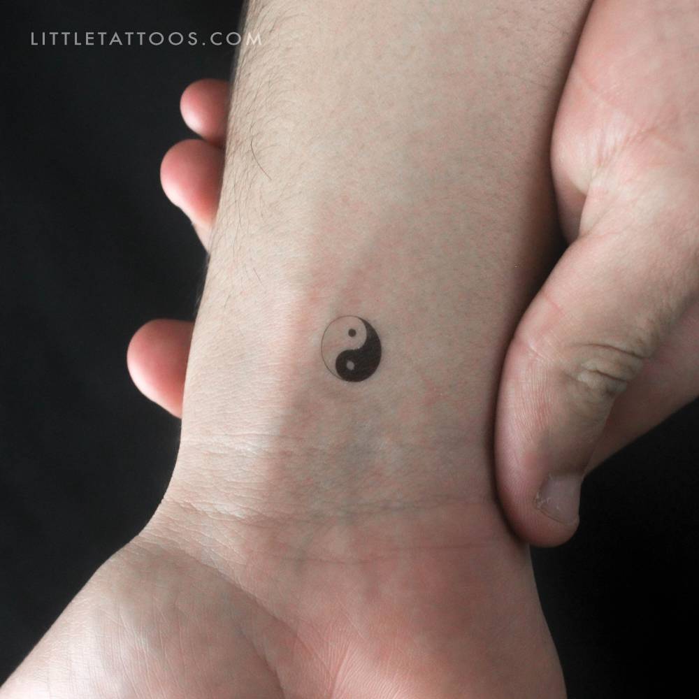 Minimalistic style Yin Yang temporary tattoo placed on the wrist.