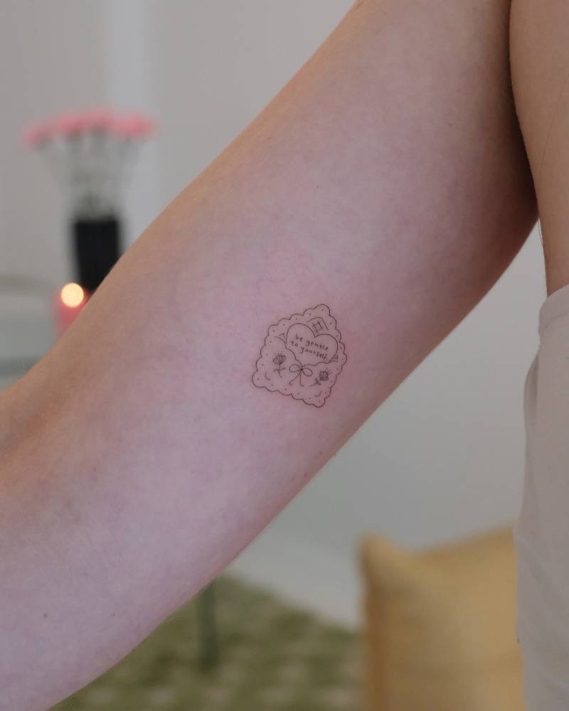 Love letter tattoo in fine line style placed on the inner arm.