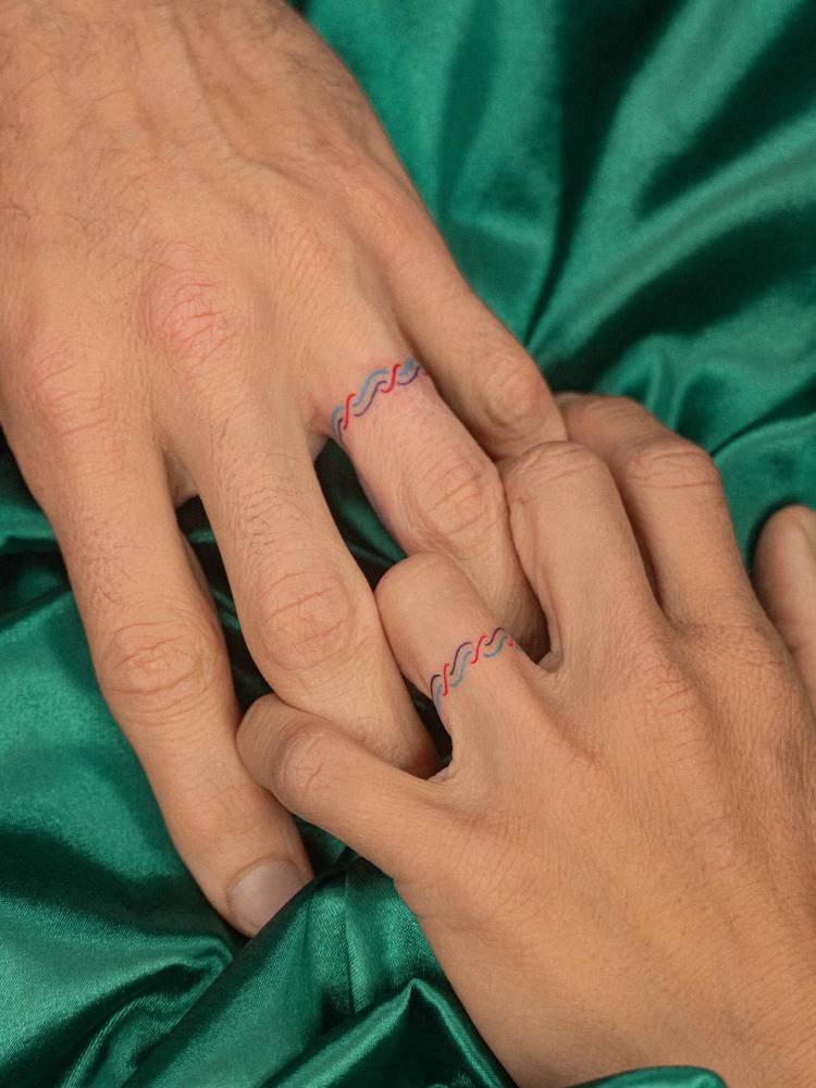 Matching colorful ring tattoo for couple.