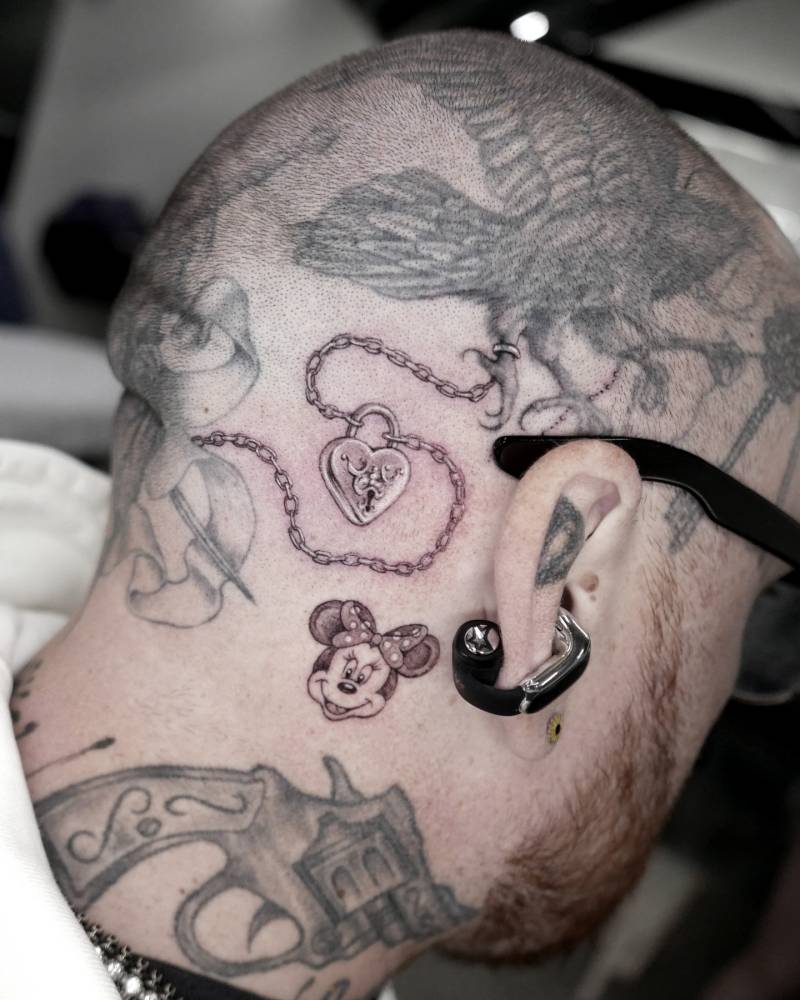 Minnie Mouse and heart padlock pendant tattoos done for Keith "Bang Bang" McCurdy.