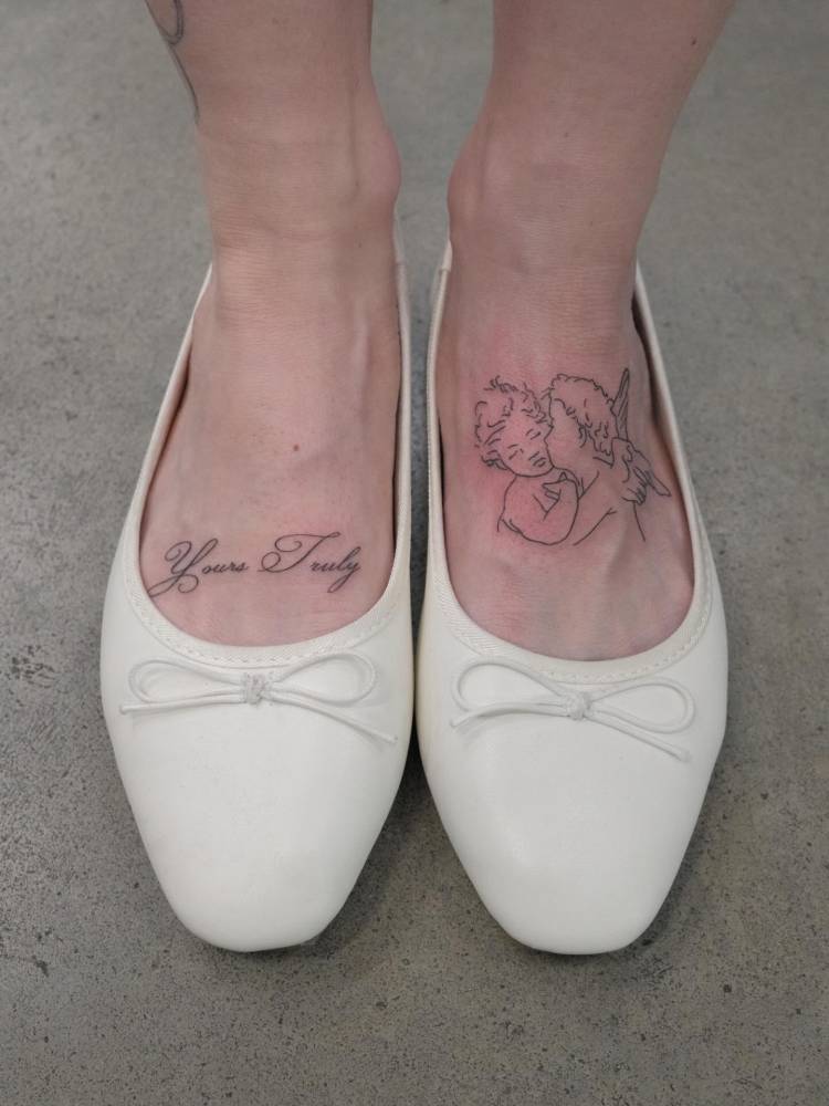 "Yours Truly" and 'The First Kiss' tattoos done on the feet.