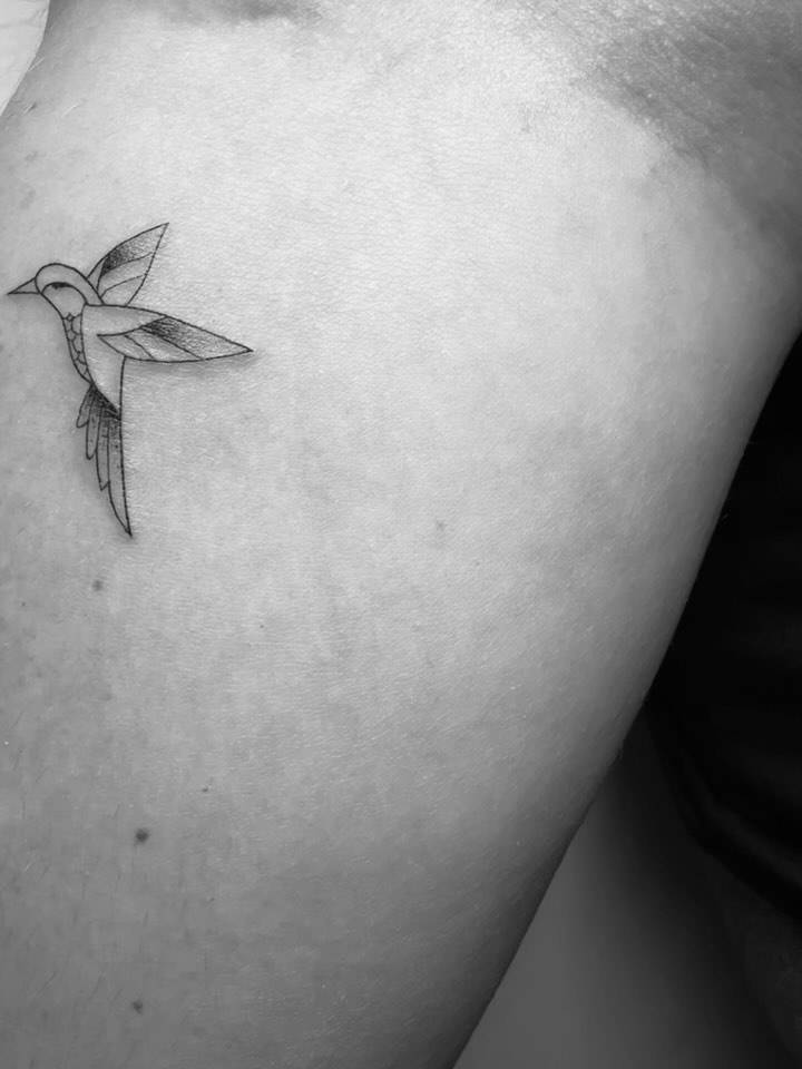 Illustrative style hummingbird tattoo located on the inner forearm.