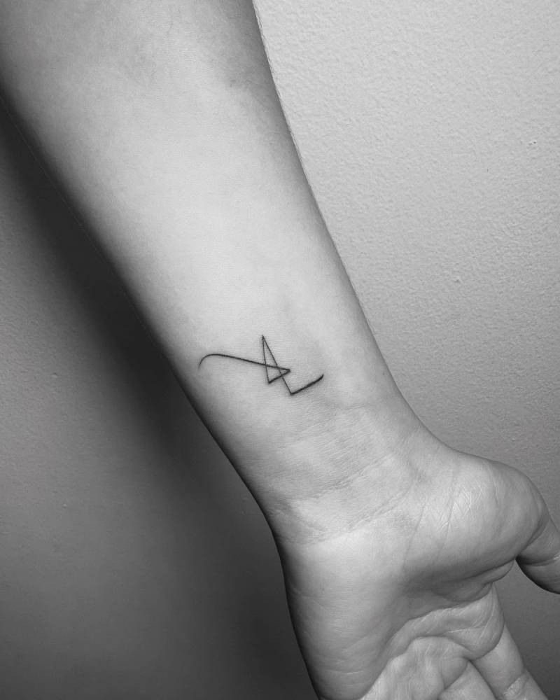 Abstract line tattoo located on the wrist.