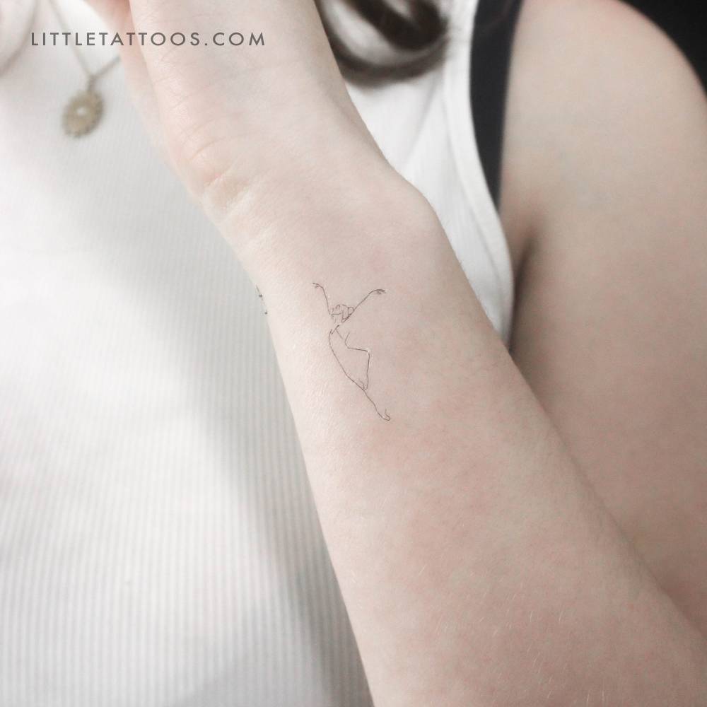 Fine line ballerina temporary tattoo located on the wrist.